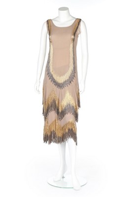 Lot 61 - A Chanel couture beaded beige chiffon flapper...