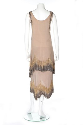 Lot 61 - A Chanel couture beaded beige chiffon flapper...