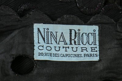 Lot 96 - An early Nina Ricci black cutwork crêpe dinner...