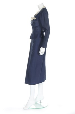 Lot 124 - A Jacques Fath couture navy wool day suit,...