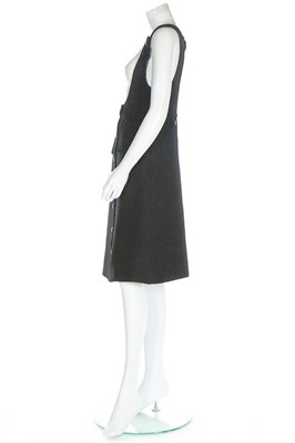 Lot 175 - A Courrèges black wool pinafore dress, circa...
