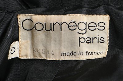Lot 175 - A Courrèges black wool pinafore dress, circa...