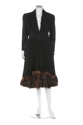 Lot 255 - A black wool coat with fur trimmed hem, 1940s,...