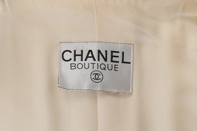 Lot 154 - A Chanel white tweed suit, late 1990s,...