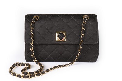 Lot 8 - A Chanel black quilted jersey handbag, 1980s,...