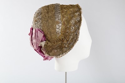 Lot 102 - An ornate gold lace bonnet, German, circa 1855,...