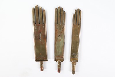 Lot 387 - Three brass glove irons, circa 1900, two...