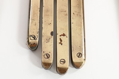 Lot 387 - Three brass glove irons, circa 1900, two...