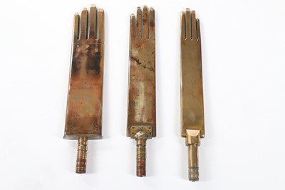 Lot 387 - Three brass glove irons, circa 1900, two...