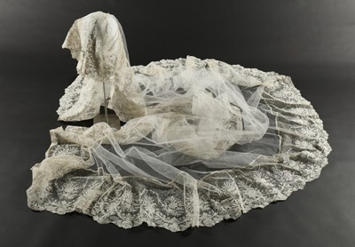 Lot 400 - A tulle bridal veil edged in 1860s Brussels...