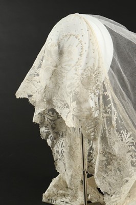 Lot 400 - A tulle bridal veil edged in 1860s Brussels...