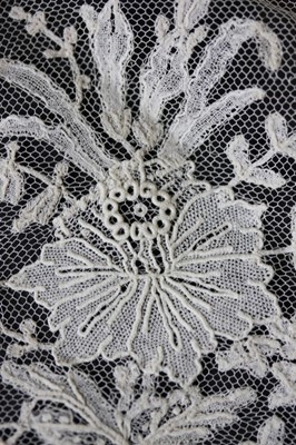 Lot 400 - A tulle bridal veil edged in 1860s Brussels...