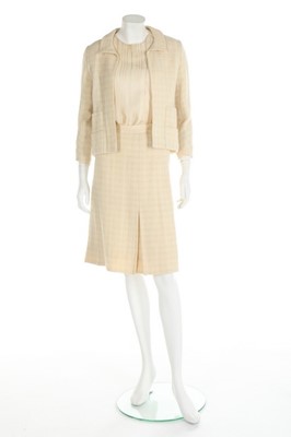 Lot 157 - A Chanel couture ivory tweed suit, 1964, broad...