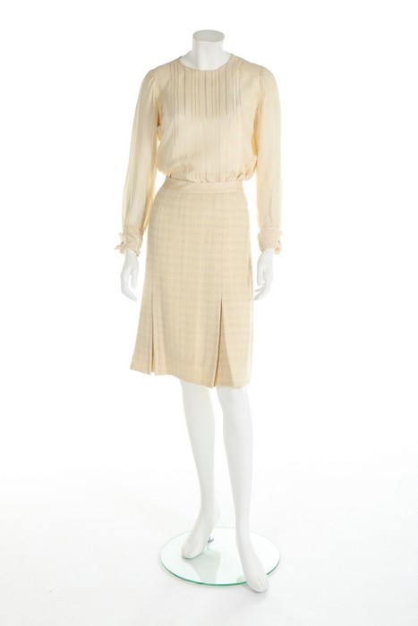 Lot 157 - A Chanel couture ivory tweed suit, 1964,