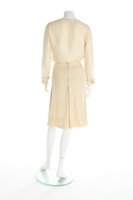 Lot 157 - A Chanel couture ivory tweed suit, 1964, broad...