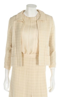 Lot 157 - A Chanel couture ivory tweed suit, 1964, broad...