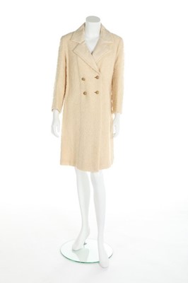 Lot 158 - A Chanel couture ivory bouclé wool coat, 1962,...