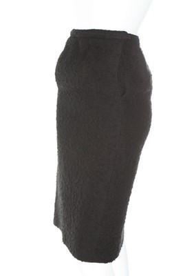 Lot 170 - A Balenciaga couture black bouclé wool suit,...