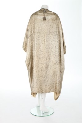 Lot 64 - A gold lamé cocoon-like opera cape, mid 1920s,...
