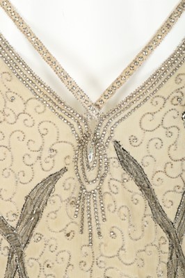Lot 97 - An ivory crêpe georgette and chantilly lace...