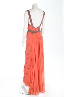 Lot 98 - A beaded salmon-pink chiffon evening gown,...