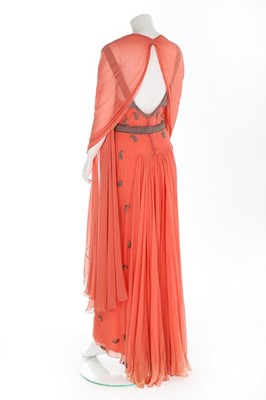 Lot 98 - A beaded salmon-pink chiffon evening gown,...
