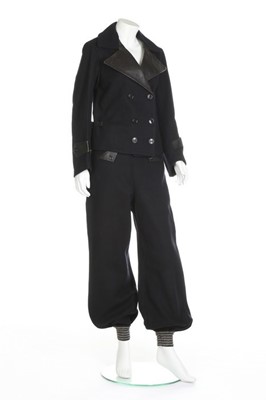 Lot 104 - A navy wool and black leather ski suit, 1936-9,...