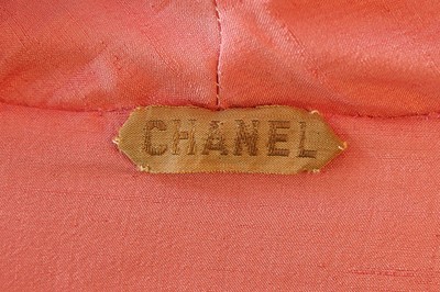 Lot 131 - A Chanel couture brocaded satin cocktail suit,...