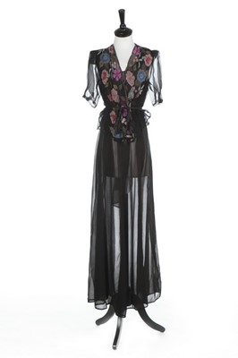 Lot 109 - A bias-cut black chiffon evening gown, circa...