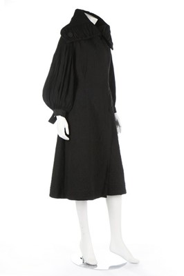 Lot 114 - A black quilted silk evening coat, 1930s, with...