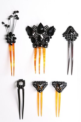 Lot 214 - A collection of jet glass beaded hair combs,...