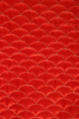 Lot 22 - An Yves Saint Laurent quilted coral satin...