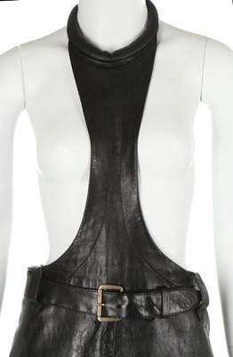 Lot 117 - A Pierre Cardin black leather pinafore, 1967,...