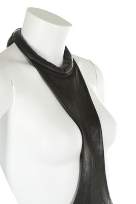 Lot 117 - A Pierre Cardin black leather pinafore, 1967,...