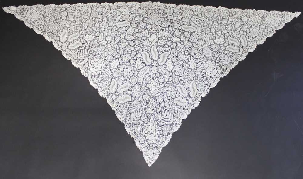 Lot 411 - A good Honiton bobbin lace tri-angular shawl,...