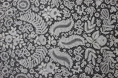 Lot 411 - A good Honiton bobbin lace tri-angular shawl,...