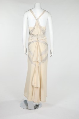 Lot 115 - A bias-cut white beaded dress, circa 1930,...