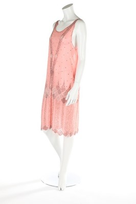 Lot 142 - A pale pink chiffon flapper dress, circa...