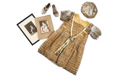 Lot 139 - A little girl's gold lace dress, late...