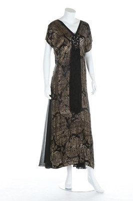 Lot 199 - A brocaded black and gold lame evening gown...