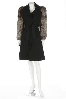 Lot 250 - A black wool coat with fox fur sleeves, late...