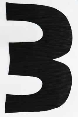 Lot 314 - An Issey Miyake curved and pleated black...