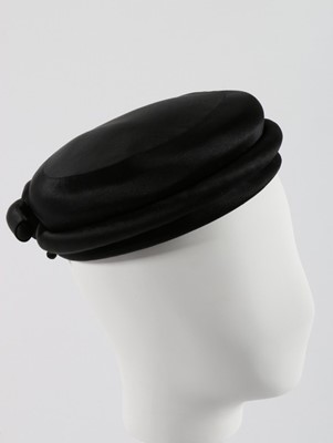 Lot 135 - A Balenciaga black satin toque, circa 1960,...