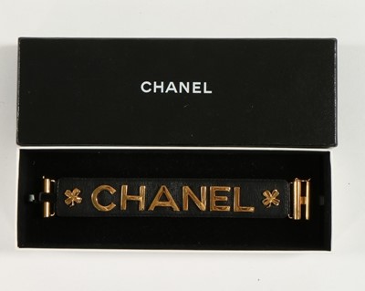 Lot 198 - A Chanel black leather cuff, 1998, stamped to...