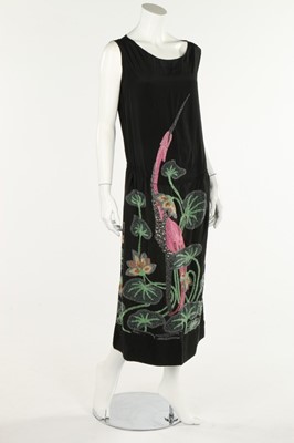 Lot 233 - A black silk dress with large beaded flamingo,...