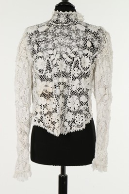 Lot 304 - An Irish crocheted short jacket, circa 1930,...