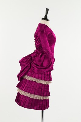 Lot 315 - A crimson satin girl's dress, circa 1885, the...