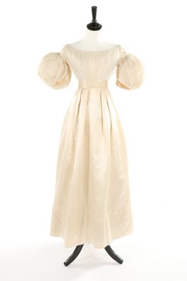 Lot 344 - An ivory tulle and satin dress, late 1820s,...