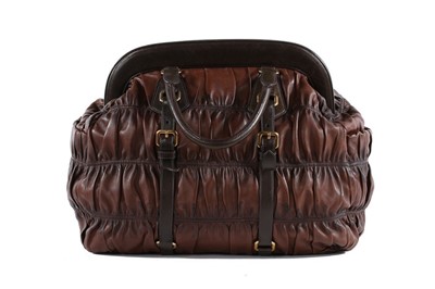 Lot 146 - A Prada brown ruched Nappa leather holdall,...