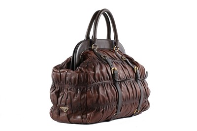 Lot 146 - A Prada brown ruched Nappa leather holdall,...